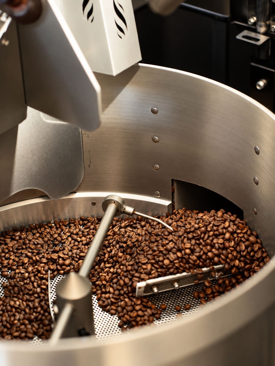 Freshly roasted coffee turning in the roaster's cooling tray