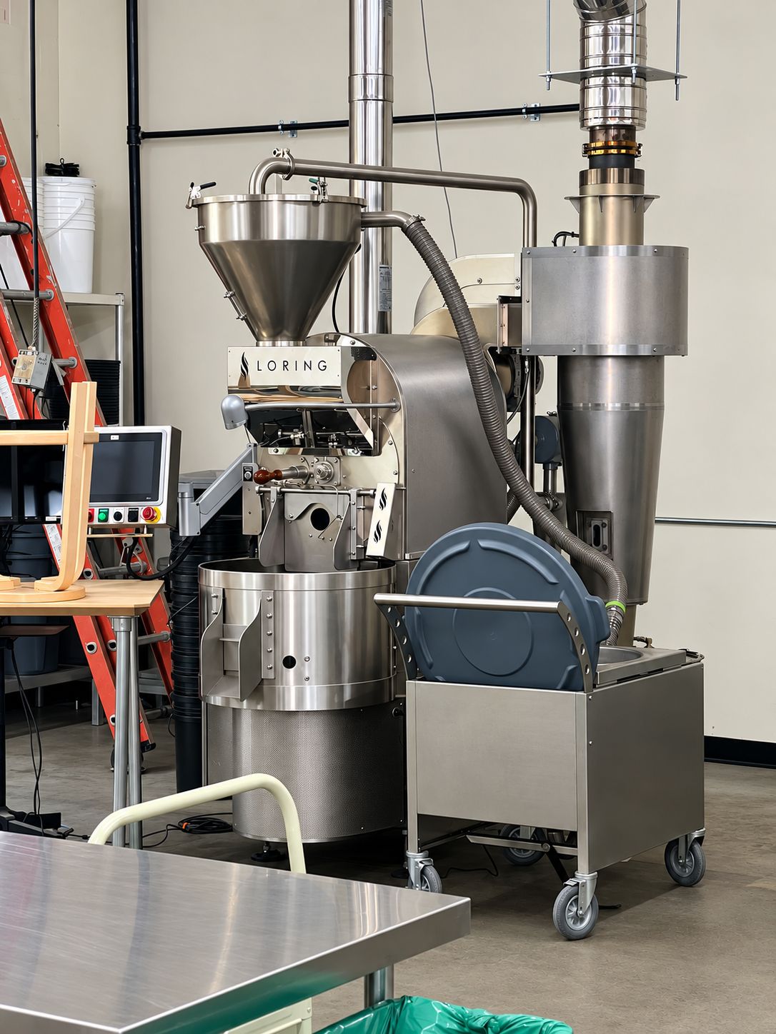Our Loring roaster at the roastery, with its hopper, cooling tray and chaff collector