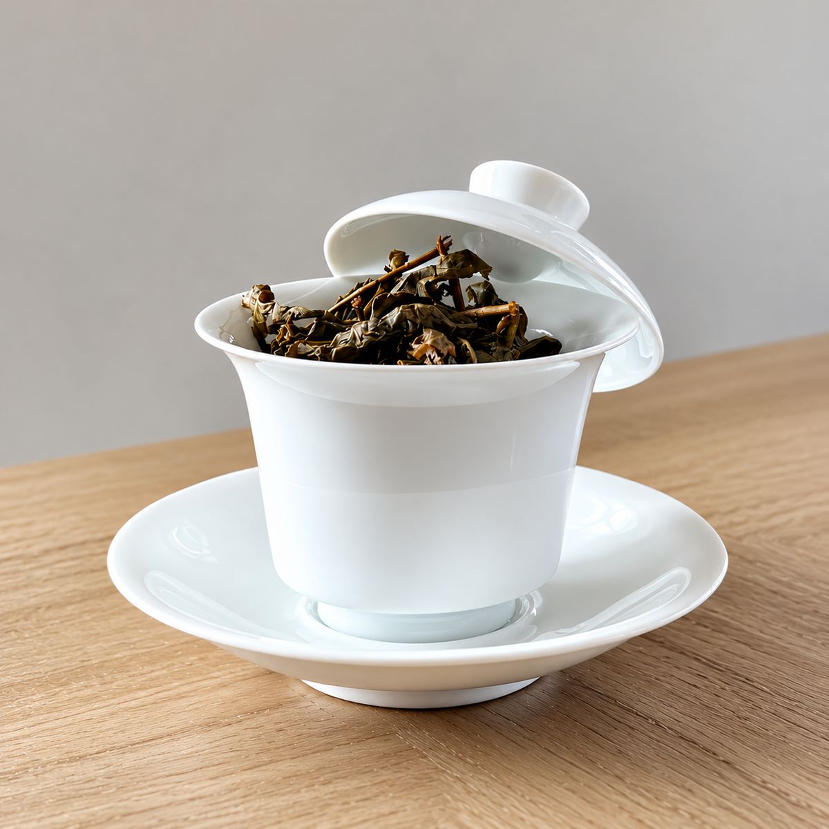 Oolong leaves opening in a white porcelain gaiwan